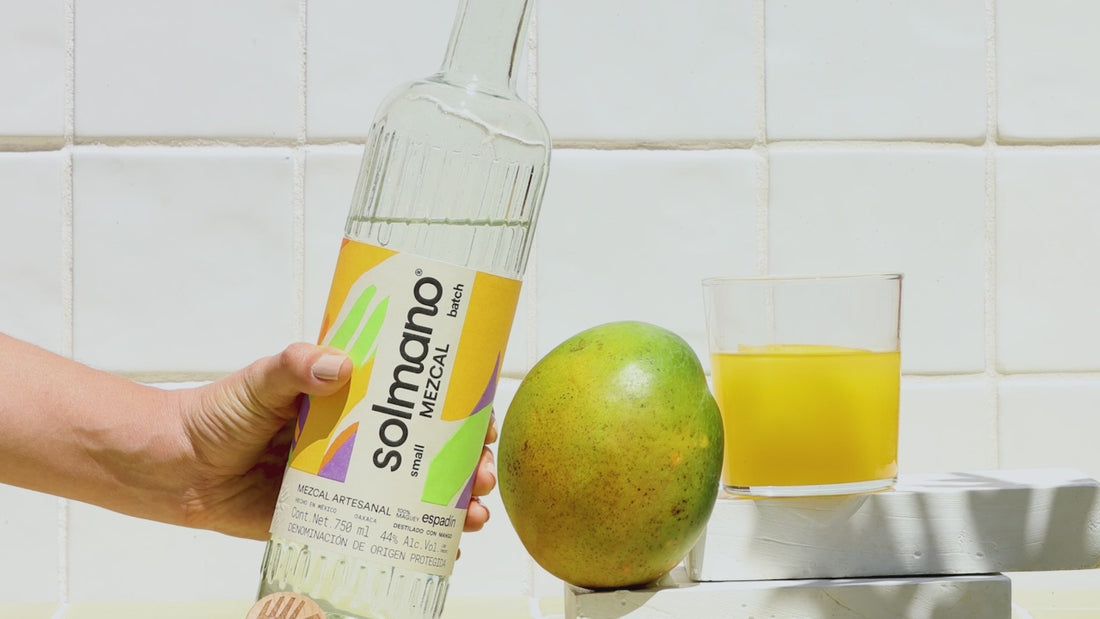 hand pouring liquid from bottle into glass